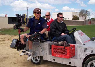 Ron and Tim Walker riding on a Grip Trix electric car